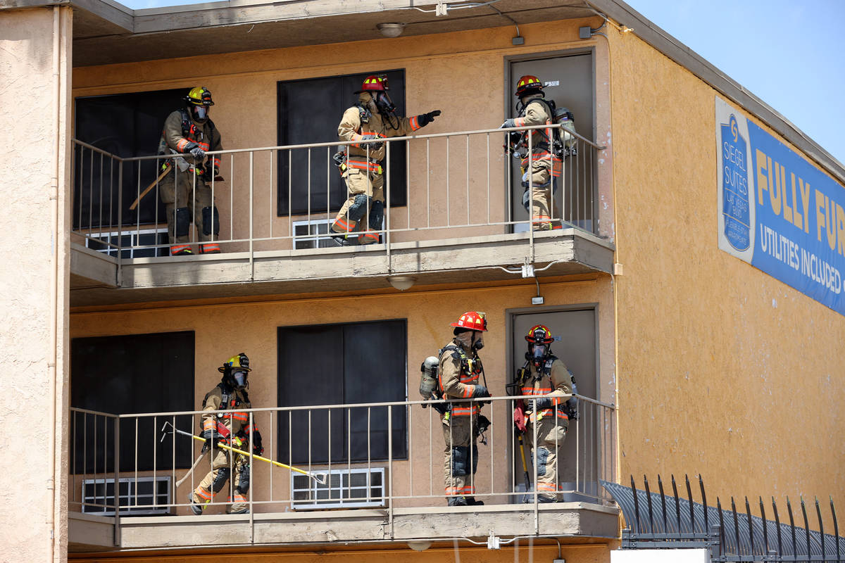 Las Vegas and Clark County firefighters check to see if residences are occupied while battling ...