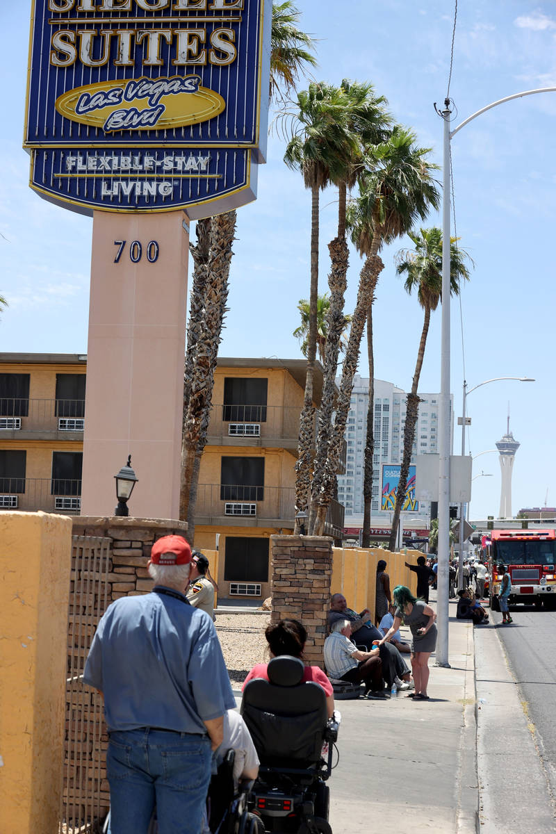 Residents wait while Las Vegas and Clark County firefighters battle a fire at Siegel Suites at ...