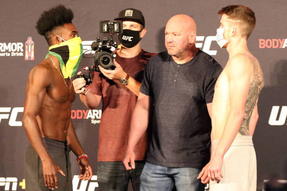 Aljamain Sterling, left, and Cory Sandhagen, right, engage in a staredown after making weight f ...