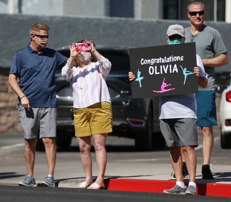 People attend the Las Vegas Academy drive-through graduation in Las Vegas, Saturday, June 6, 20 ...