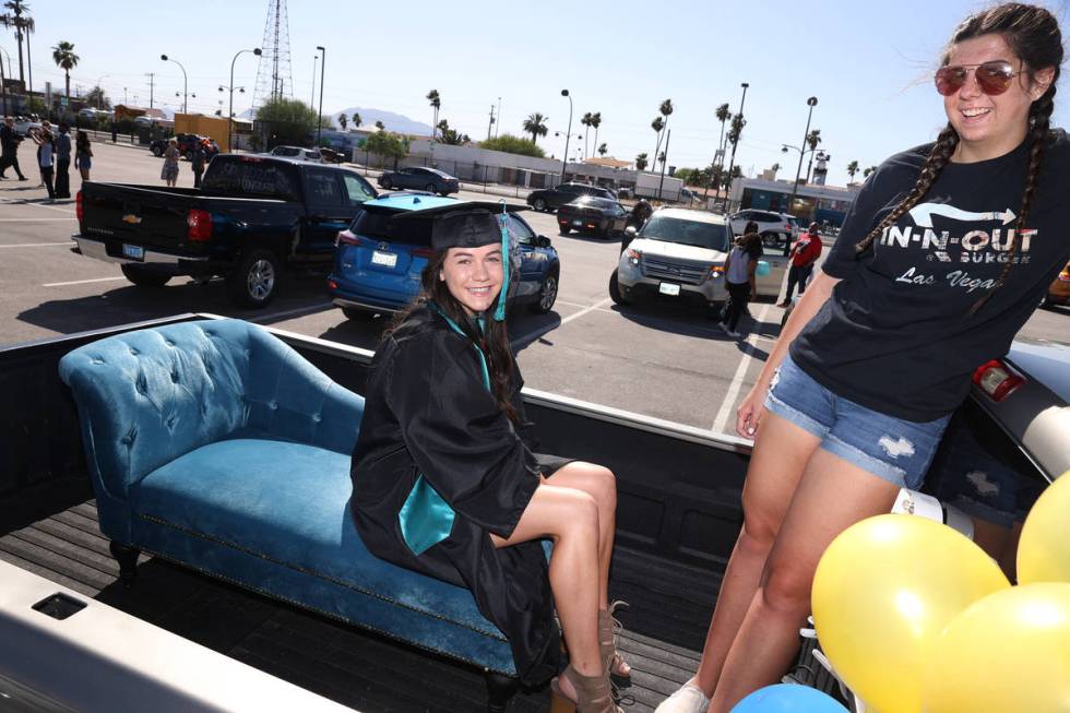 Senior Devyn Swain, left, 18, with her friend Shaunie Mangum, get ready for a drive-through gra ...