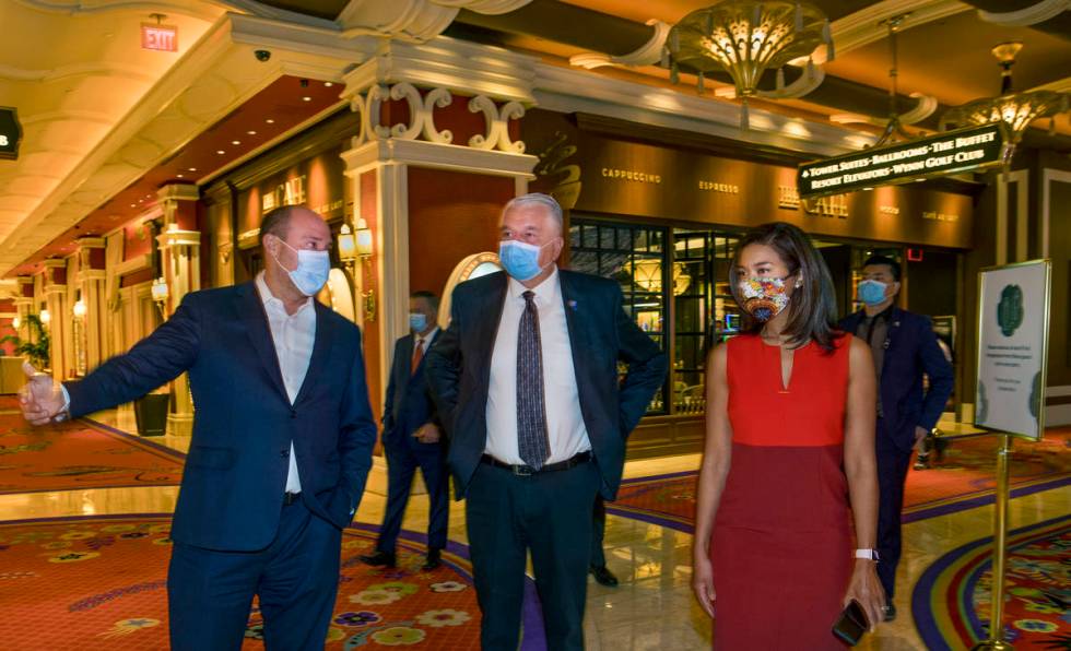 Wynn Las Vegas CEO Matt Maddox, left, talks with Gov. Steve Sisolak and Sandra Morgan, chairwom ...