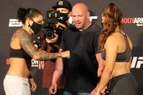 UFC women's featherweight champion Amanda Nunes, left, prepares to give a fist bump to Felicia ...