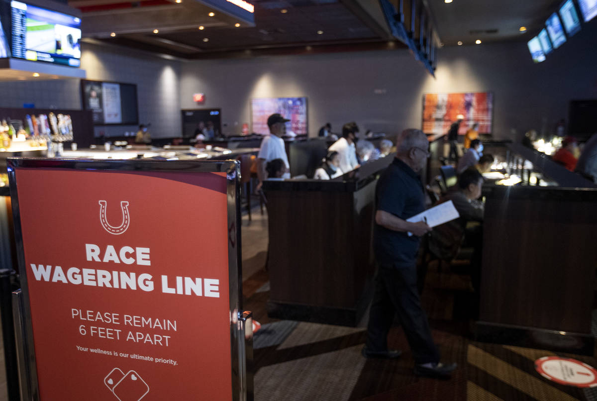 The Race and Sports Book at Palace Station asks customers to remain six feet apart to slow the ...