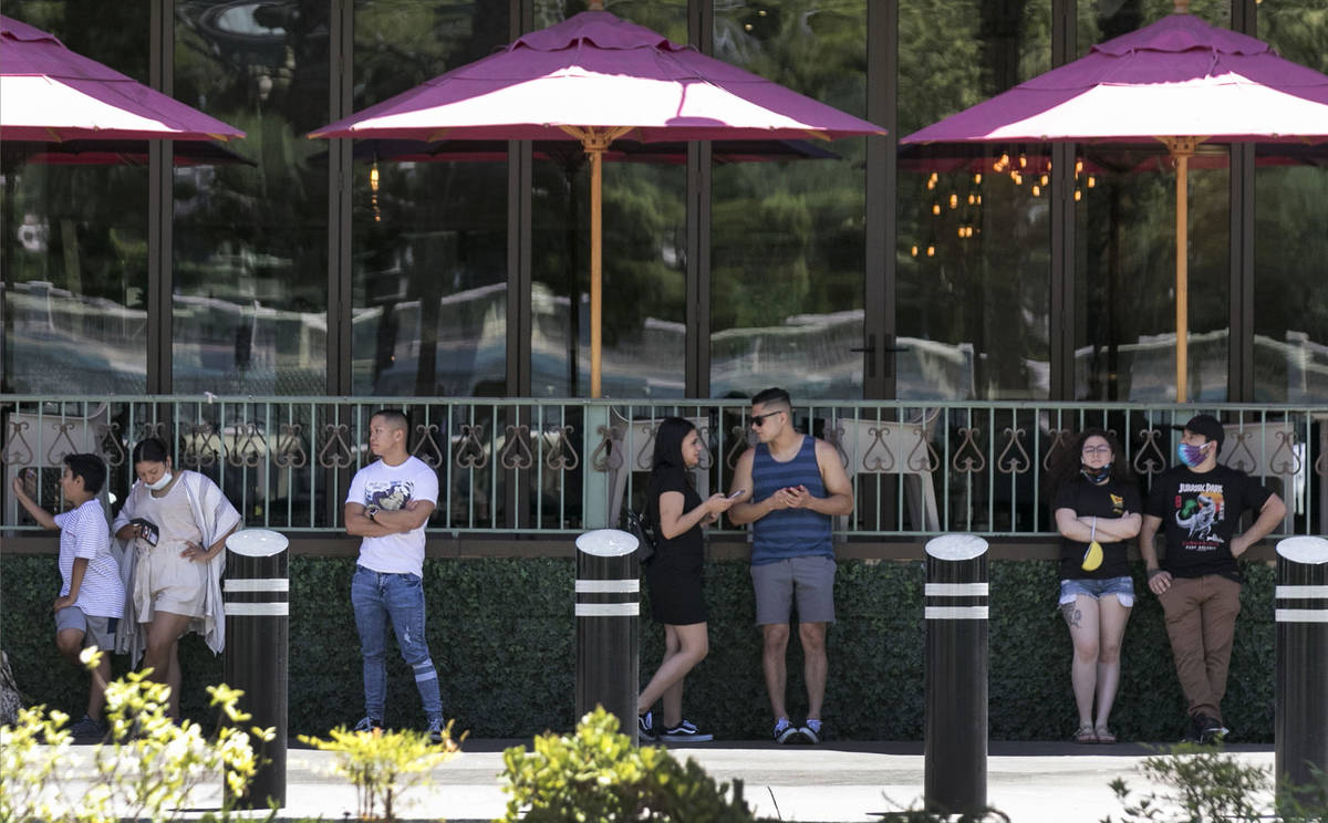 Patrons wait in line to enter HEXX Kitchen + Bar on Sunday, June 7, 2020, in Las Vegas. On Sund ...