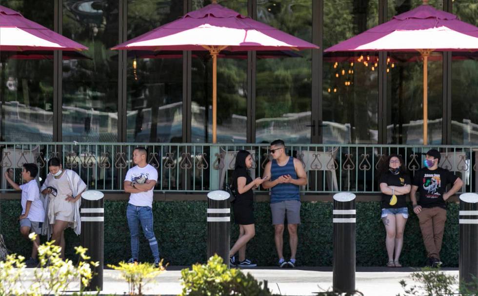 Patrons wait in line to enter HEXX Kitchen + Bar on Sunday, June 7, 2020, in Las Vegas. On Sund ...