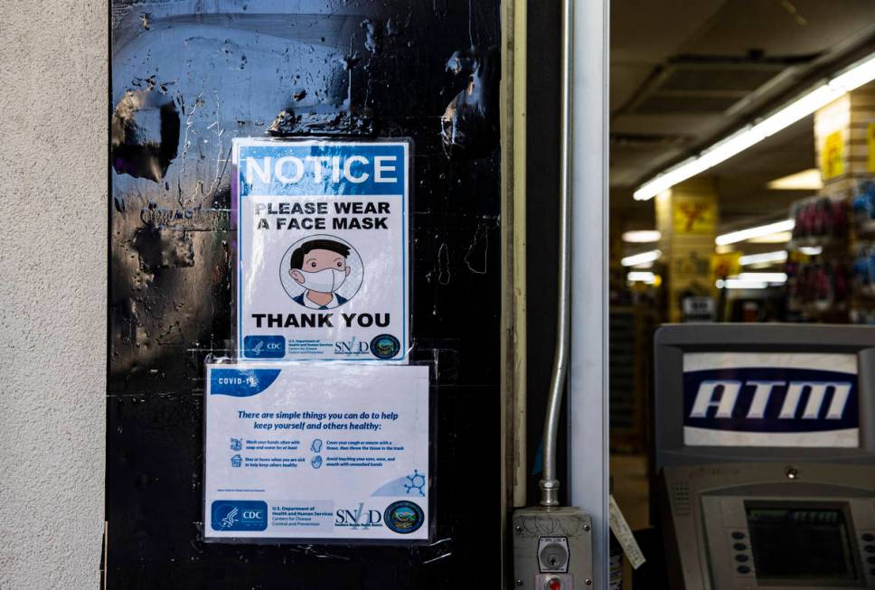 A notice require face masks at a souvenir shop at the Fremont Street Experience in downtown Las ...