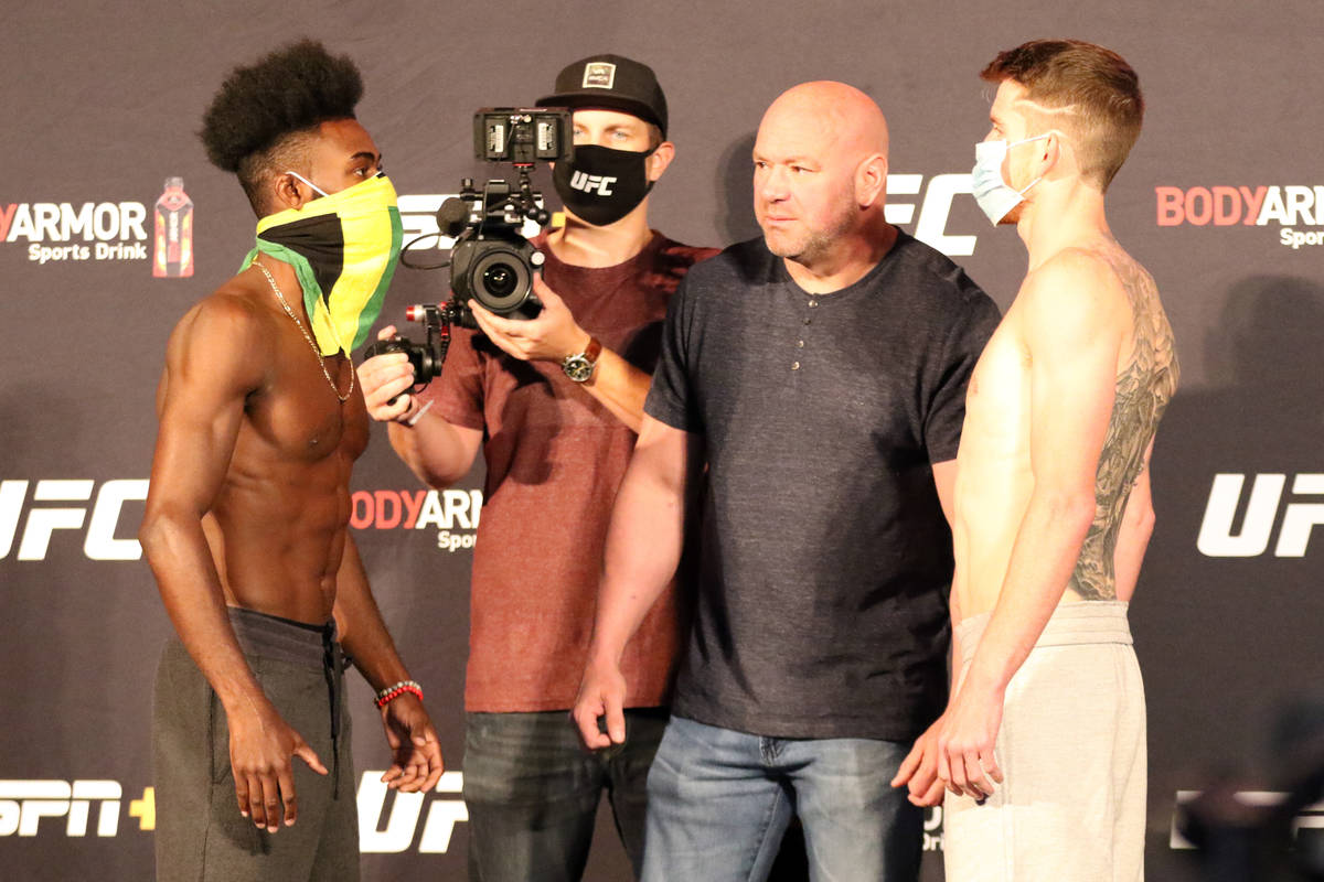 Aljamain Sterling, left, and Cory Sandhagen, right, engage in a staredown after making weight f ...