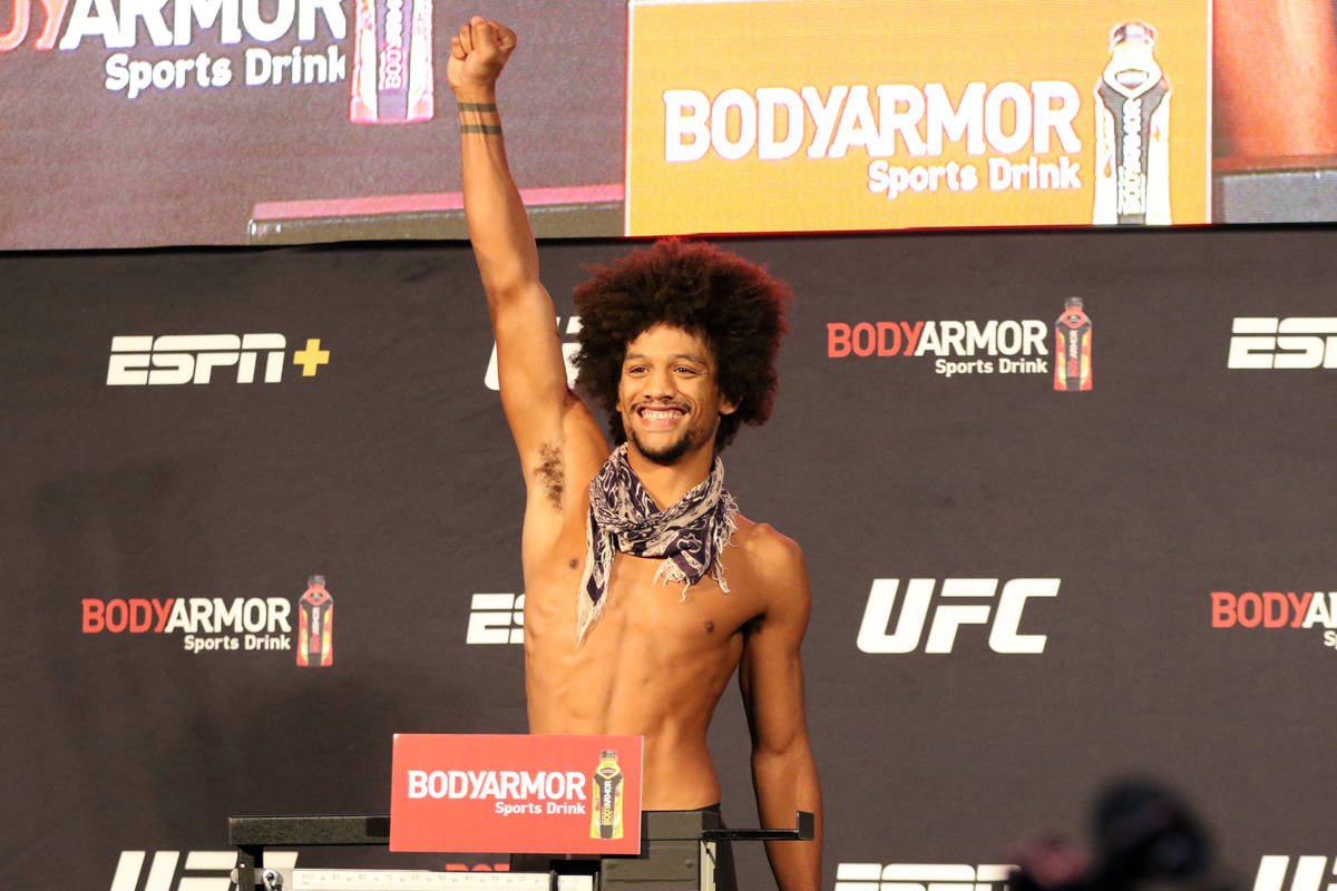 UFC featherweight Alex Caceres poses on the scale at the UFC Apex after making weight for UFC 2 ...