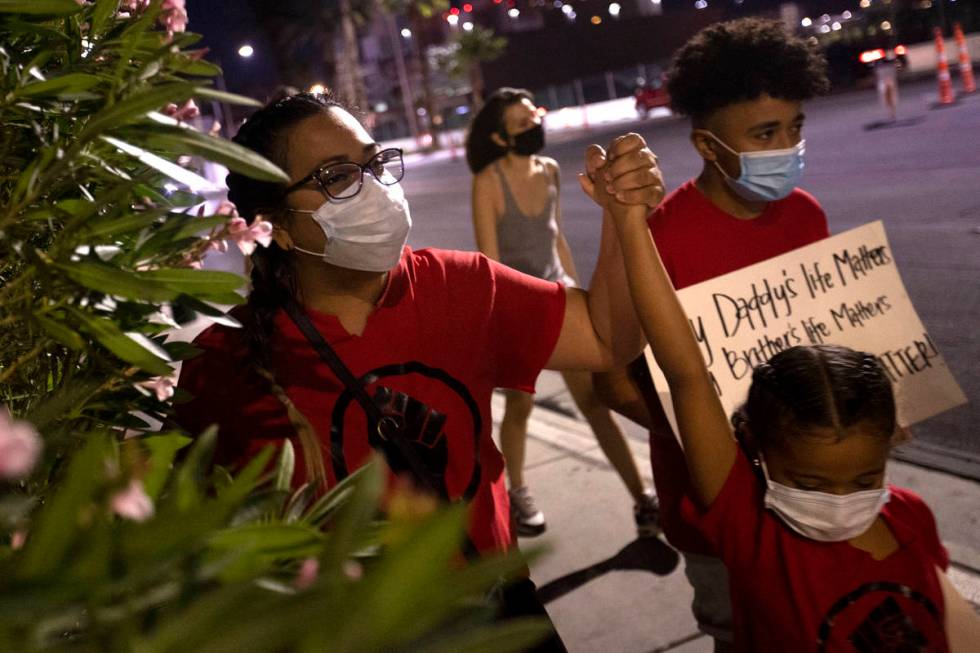 A small group of people march down Las Vegas Boulevard in protest of police brutality and the d ...