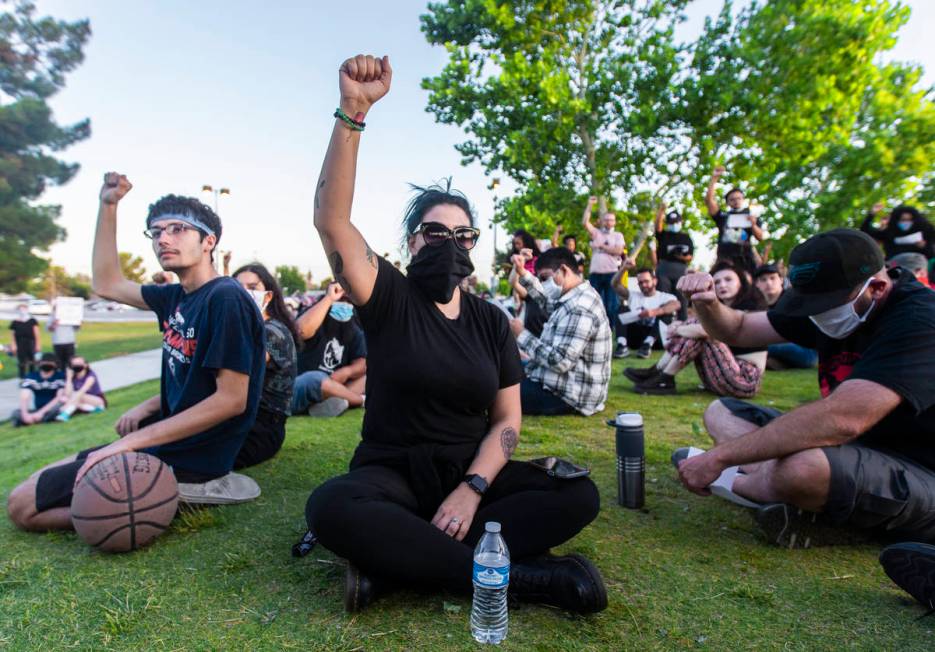 Protesters raise their fists in solidarity during a press conference hosted by Organizing the S ...