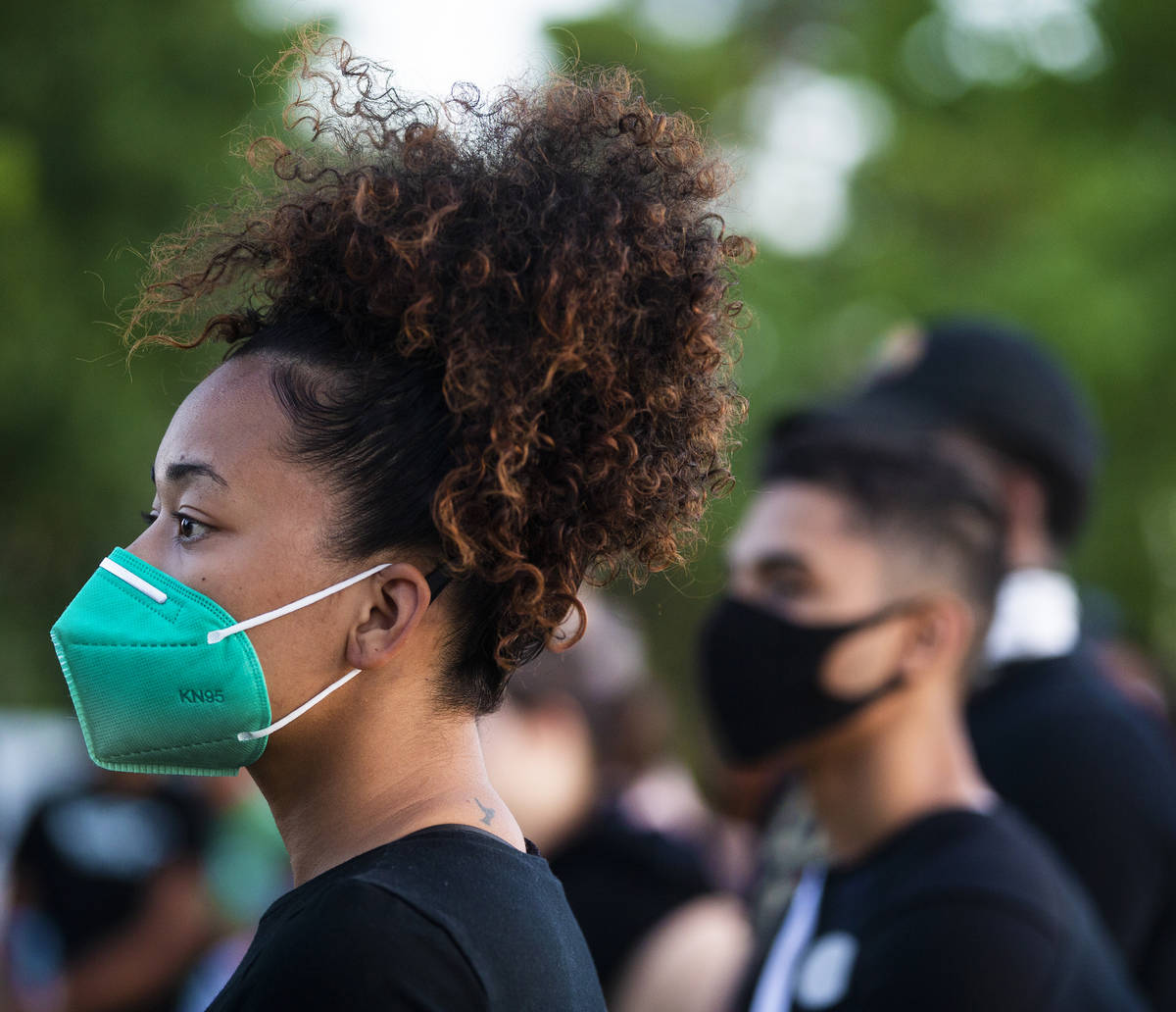 Nakita Fletcher, left, listens to a speaker during a press conference hosted by Organizing the ...