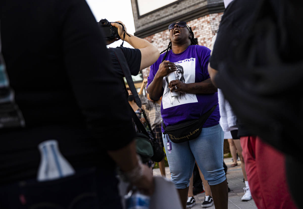 Katrina Johnson holds a candle while wearing a shirt depicting her cousin, Charleena Lyles, who ...