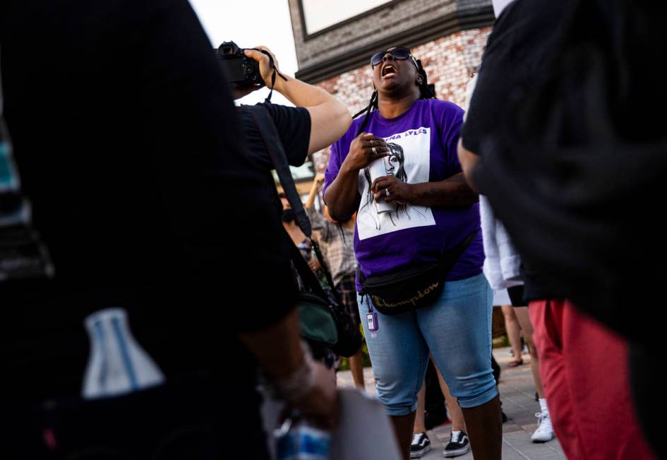 Katrina Johnson holds a candle while wearing a shirt depicting her cousin, Charleena Lyles, who ...