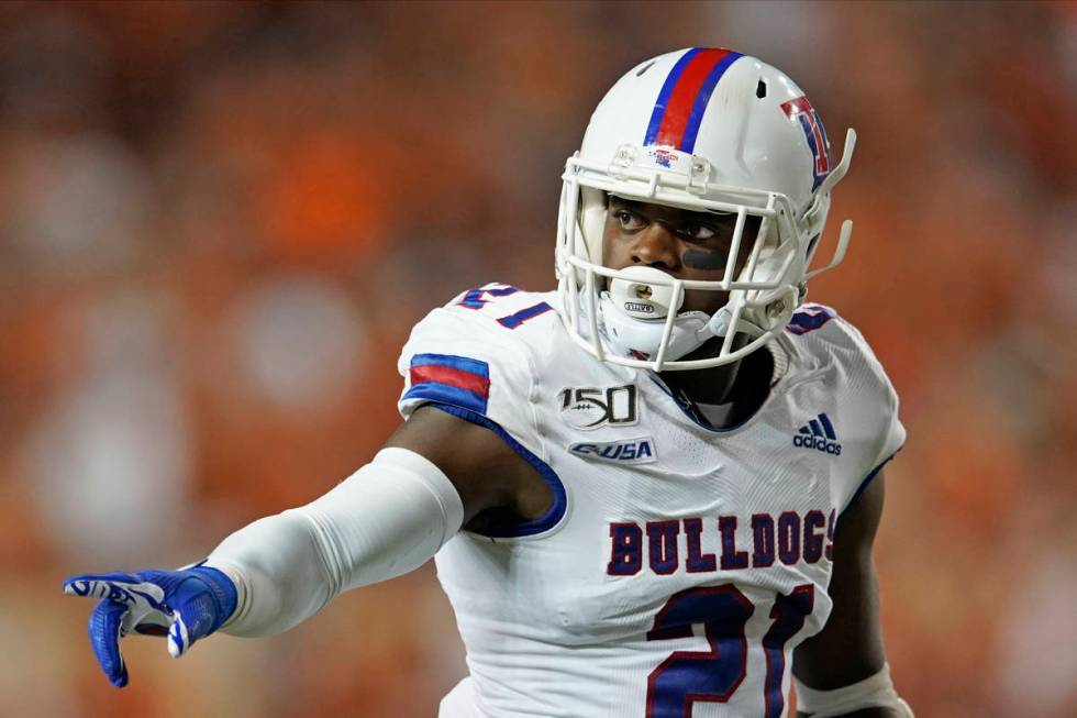 Louisiana Tech's Amik Robertson (21) signals against Texas during the second half of an NCAA co ...