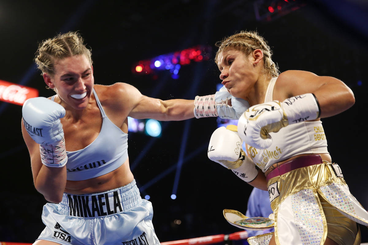 Mikaela Mayer, left, connects a punch against Lizbeth Crespo in the womenÕs super featherw ...