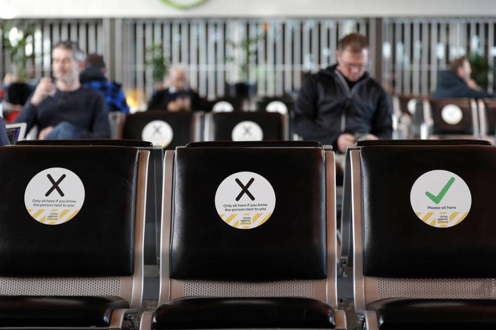 FILE - In this May 14, 2020, file photo, passengers wait to board their flight at Christchurch ...