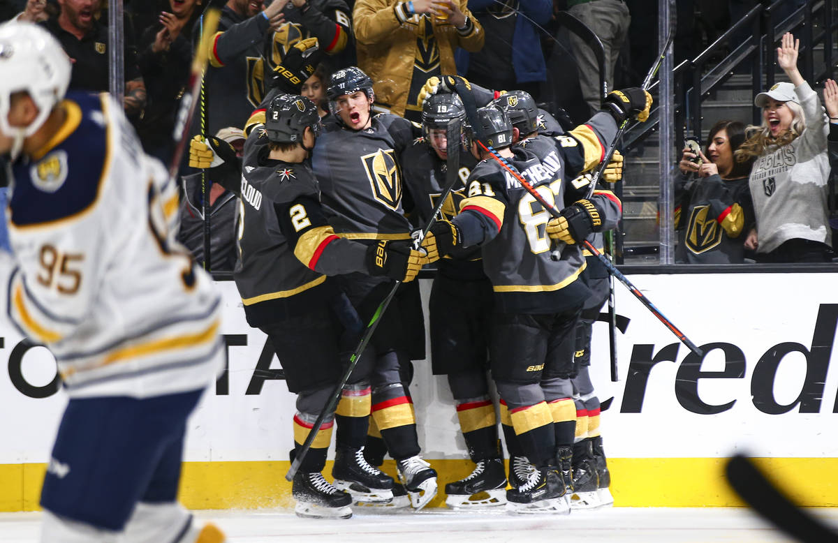 Golden Knights players celebrate a goal by Reilly Smith during the third period of an NHL hocke ...