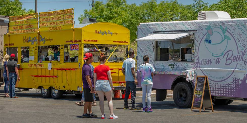 The Hot Diggity Dog Las Vegas and Spoon-a-Bowl food trucks serve customers about Desert Breeze ...