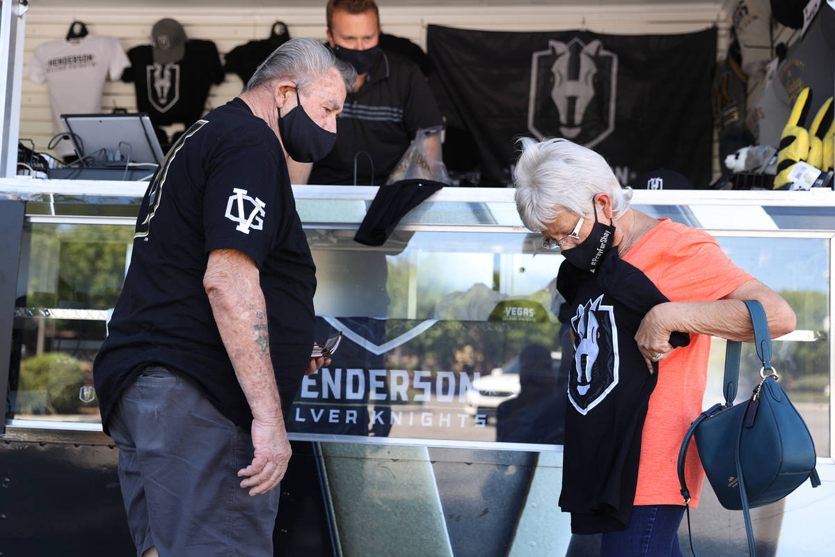 Ralph Baker, left, and his wife Sharon Baker looks at merchandise from the Henderson Silver Kni ...