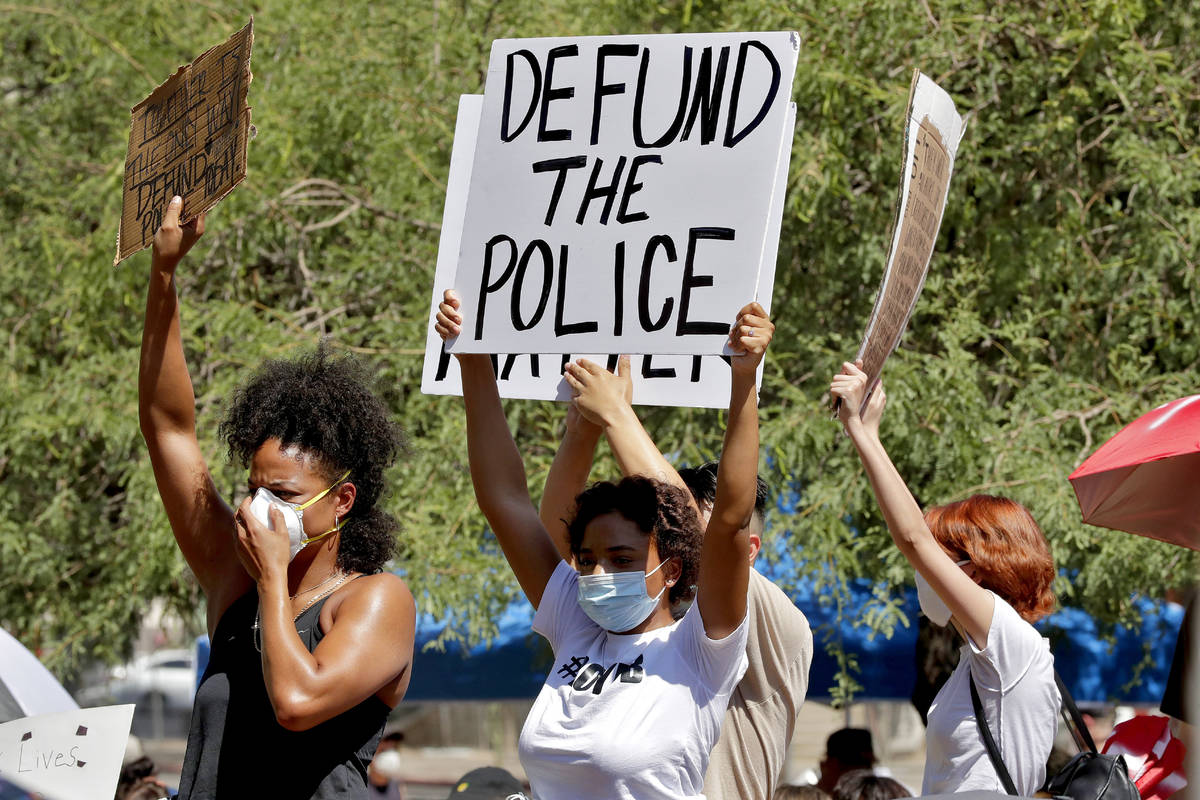 Protesters rally Wednesday, June 3, 2020, in Phoenix, demanding the Phoenix City Council defund ...