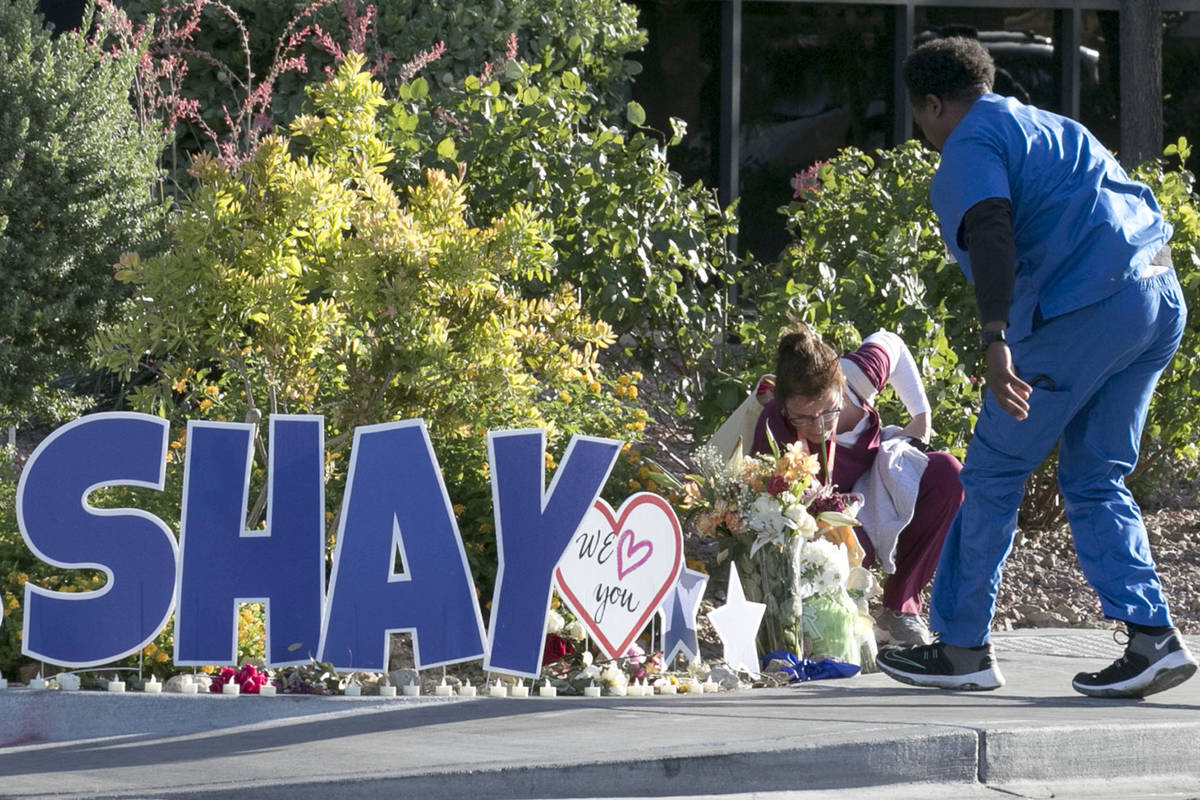 Nurses at University Medical Center (UMC) place flowers outside the hospital during A "Pray for ...