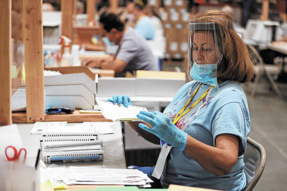 J.R. Thompson verifies ballots at the Clark County Election Department in Henderson, Wednesday, ...