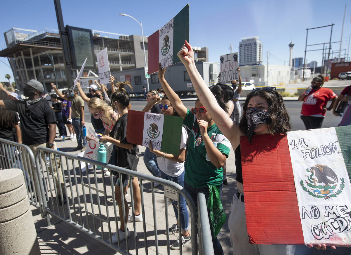 Outside Las Vegas City Hall, Leslie Fausto, right, demonstrates in an effort to defund the Metr ...