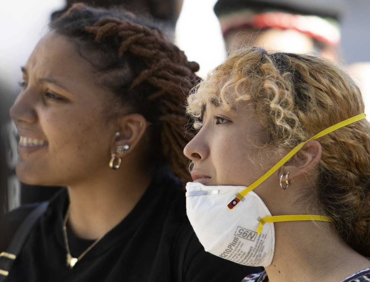 Jayla Scott, left, and Fernanda Rivera, right, get emotional while protesting in an effort to d ...