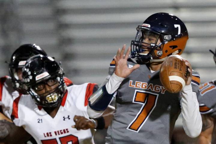 Legacy's quarterback Evan Olaes (7) looks to throw the ball as Las Vegas' Markell Jackson (57) ...