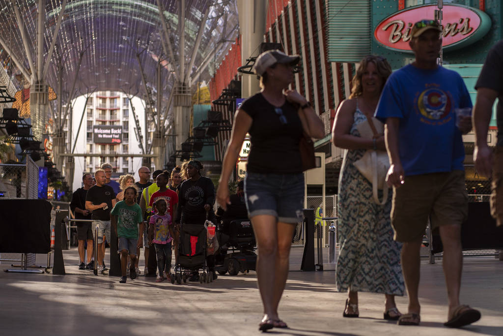 Tourists and locals return to Fremont Street Experience on the second day that casinos and othe ...