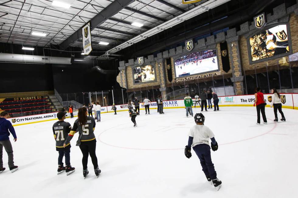 Golden Knights fans skate on the ice at City National Arena during a watch party for an away ga ...