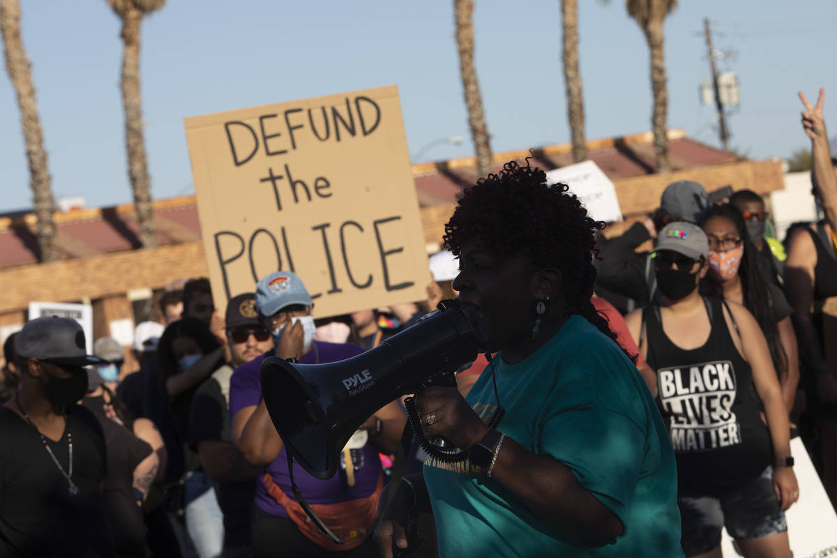 Minister JudyAnn Young speaks to the crowd at a march against police brutality near Molasky Fam ...