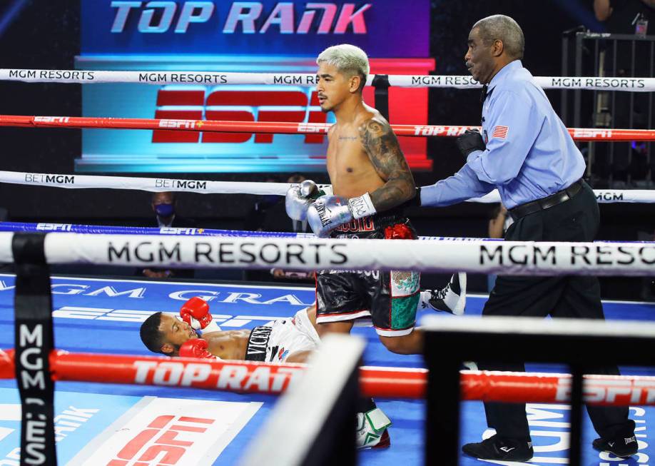 Jessie Magdaleno knocks down Yenifel Vicente during their featherweight fight Thursday, June 11 ...