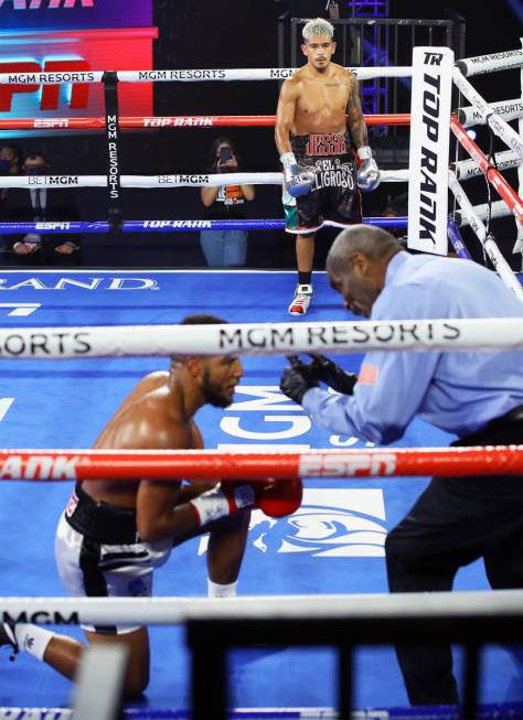 Jessie Magdaleno watches after knocking down Yenifel Vicente during their featherweight fight T ...