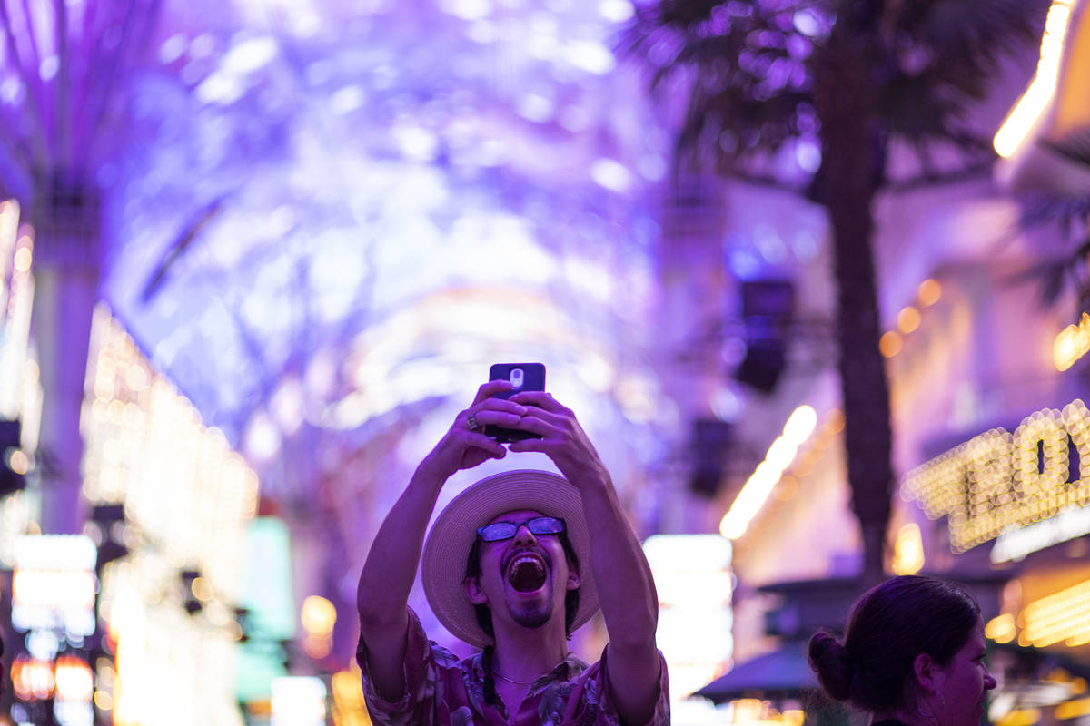 Las Vegas local Jess Medina takes an excited selfie as he visits Fremont Street Experience for ...