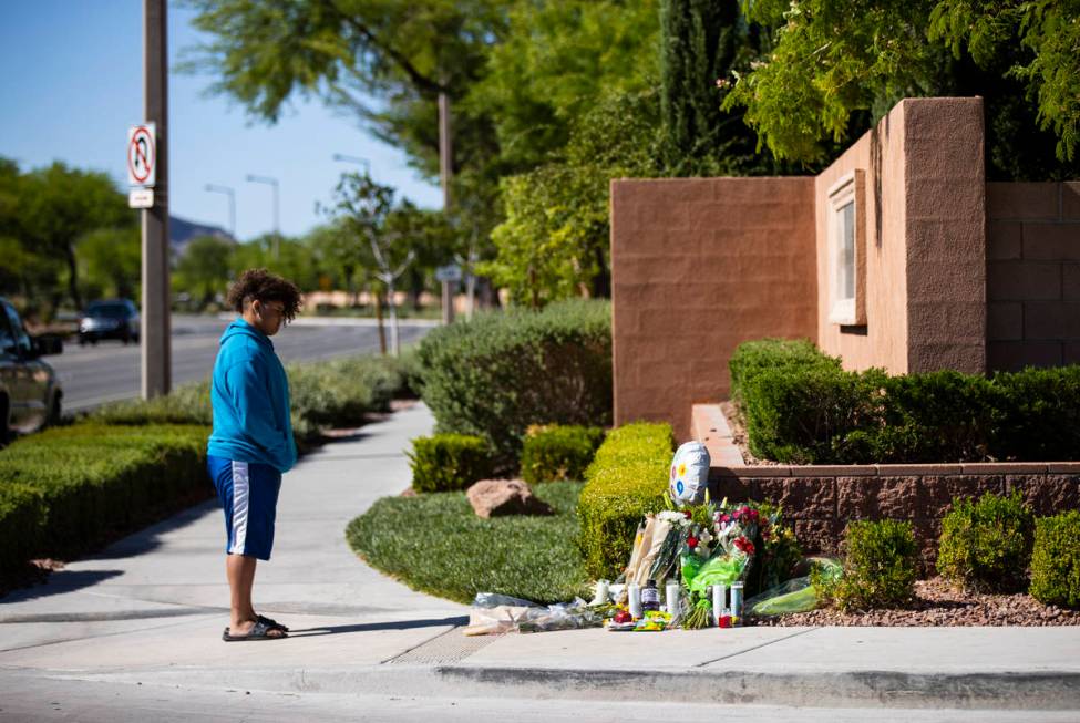 John Taylor, 14, visits the memorial left for David Cox, 18, and Brandon Cox, 14, brothers who ...