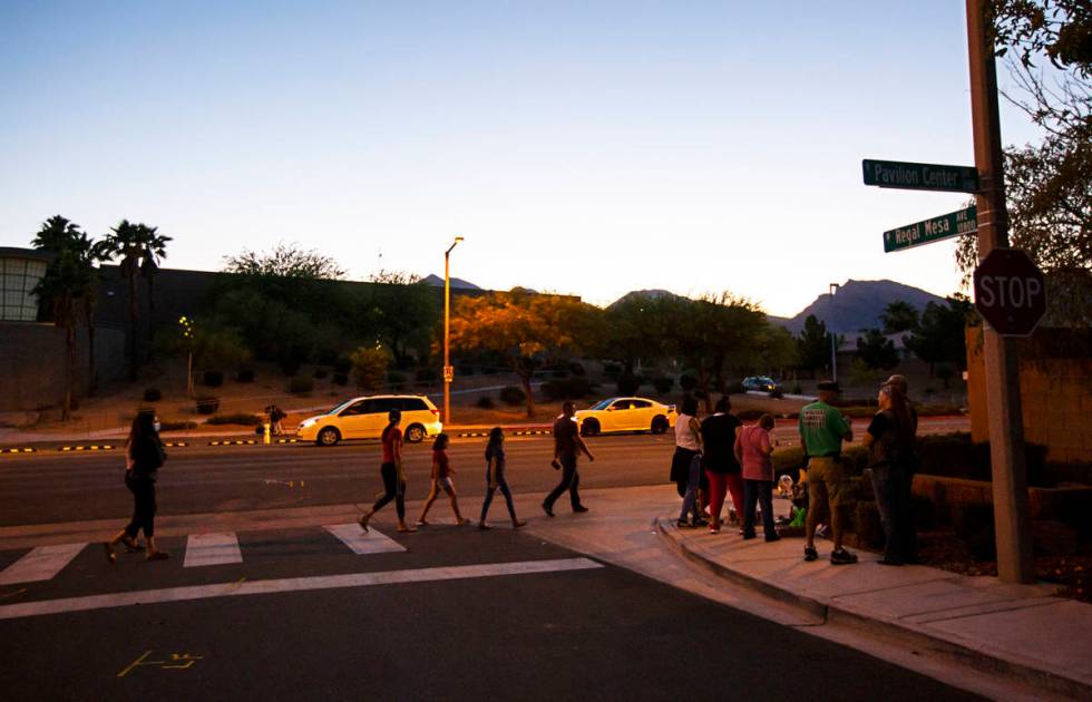 People gather for a vigil in memory of David Cox, 18, and Brandon Cox, 14, brothers who were ki ...