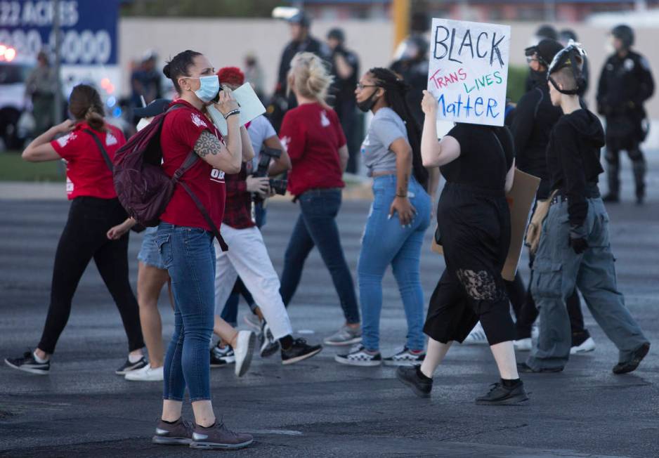 One legal observer makes a phone call during a protest against police brutality on Saturday, Ju ...