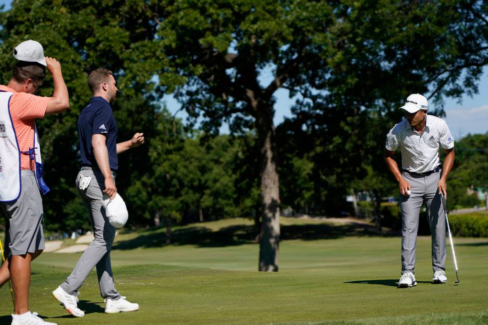 Daniel Berger, second left, walks over to Coilin Morikawa after winning Charles Schwab Challeng ...