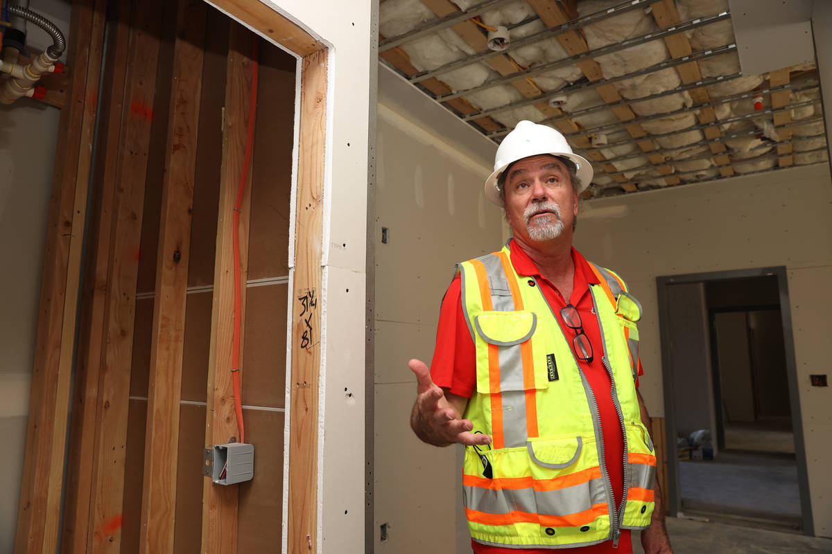 Project manager David Brown gives a tour of the construction of the first on-campus student hou ...