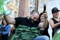 Dylan Foote, 8, of Las Vegas gets his head shaved by Jessica Buchmiller of Hue Salon in Las Veg ...