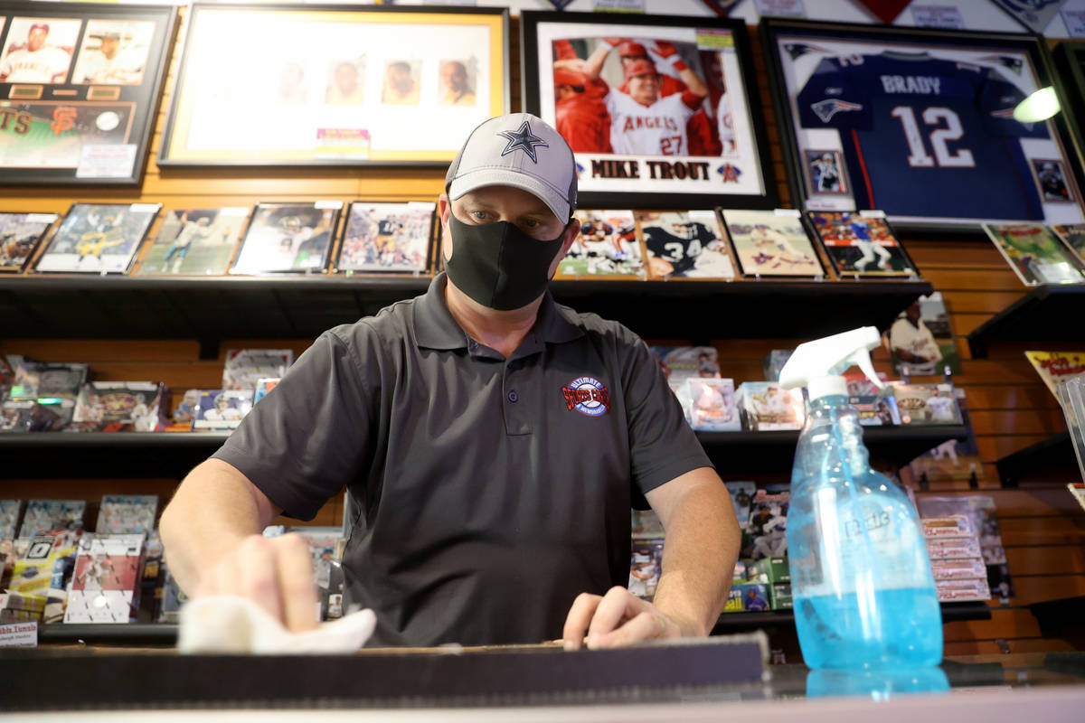 Jeremy Brown, owner of Ultimate Sports Cards and Memorabilia, works in his shop at Neonopolis i ...