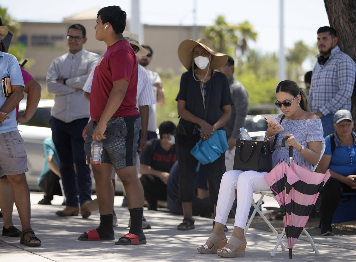 Zulue Caldera, right, brought a chair for the long wait to fix her drivers license at the Nevad ...