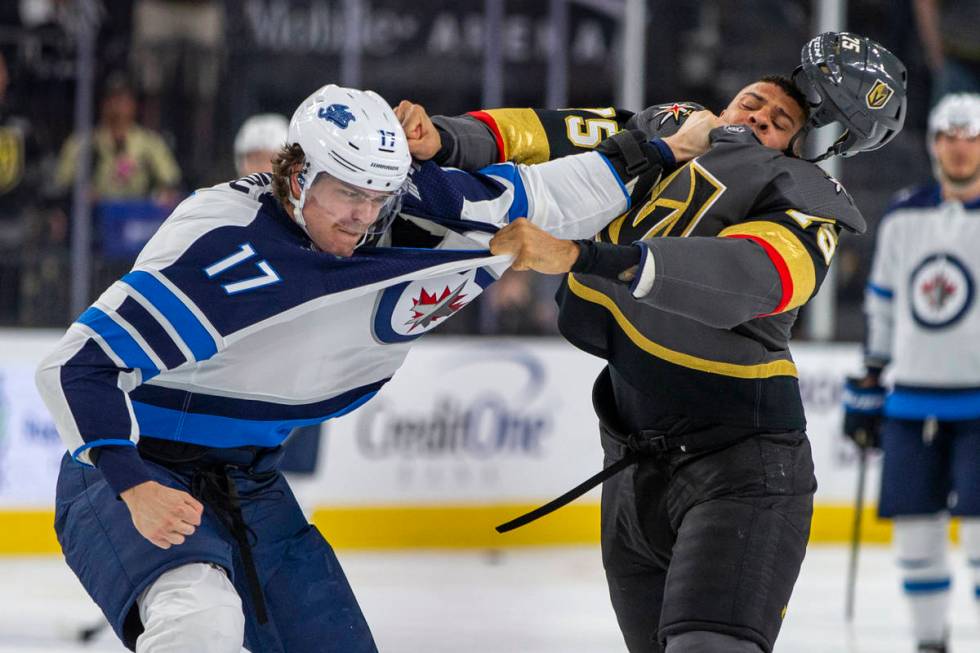 Winnipeg Jets left wing Adam Lowry (17) and Vegas Golden Knights right wing Ryan Reaves (75) sc ...