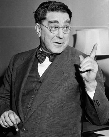 Branch Rickey, president of the Brooklyn Dodgers, pointed a professional finger at his office i ...