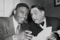 Jackie Robinson, left, Brooklyn Dodgers' second baseman, has a wide smile that almost matches t ...