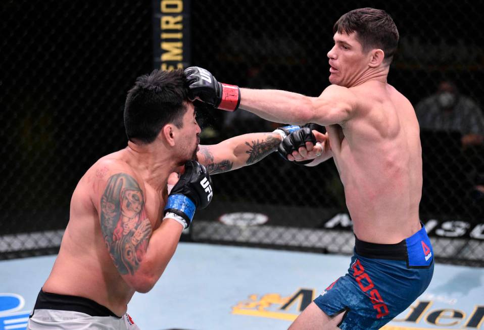 Charles Rosa punches Kevin Aguilar in their lightweight fight during the UFC Fight Night event ...