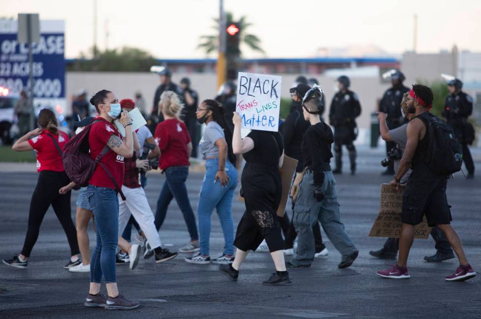 One legal observer makes a phone call during a protest against police brutality on Saturday, Ju ...