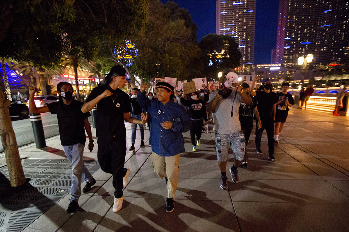 Protesters begin marching down the Strip starting at Bellagio in Las Vegas on Monday, June 15, ...